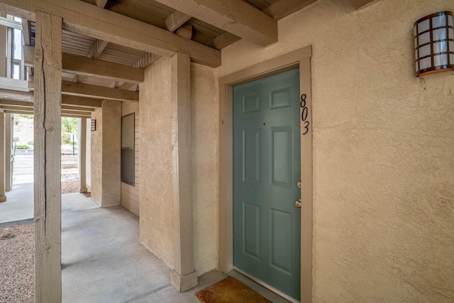 entrance to property featuring stucco siding