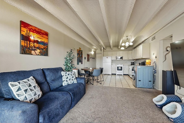 living area with visible vents, washer / dryer, light carpet, light tile patterned floors, and a notable chandelier