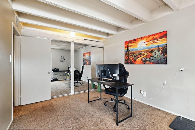 carpeted office space with baseboards and beamed ceiling