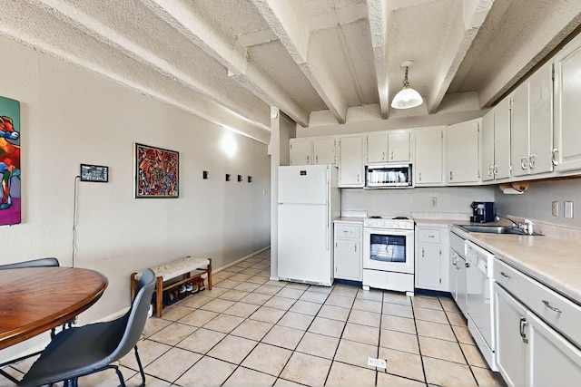 kitchen with white appliances, white cabinetry, light tile patterned floors, and light countertops
