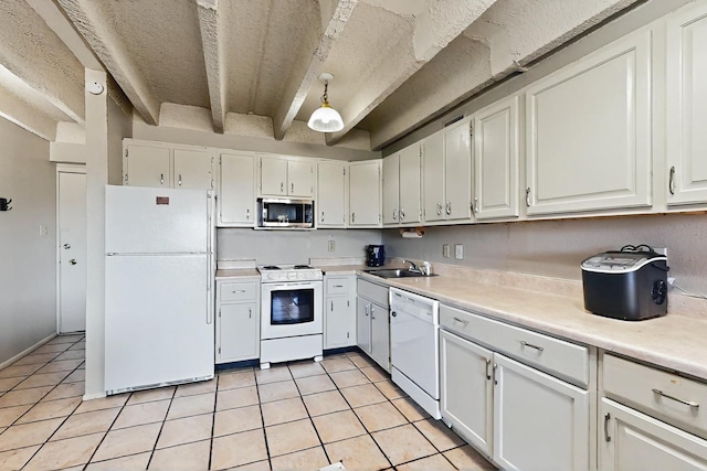 kitchen featuring a sink, light tile patterned floors, white cabinets, light countertops, and white appliances