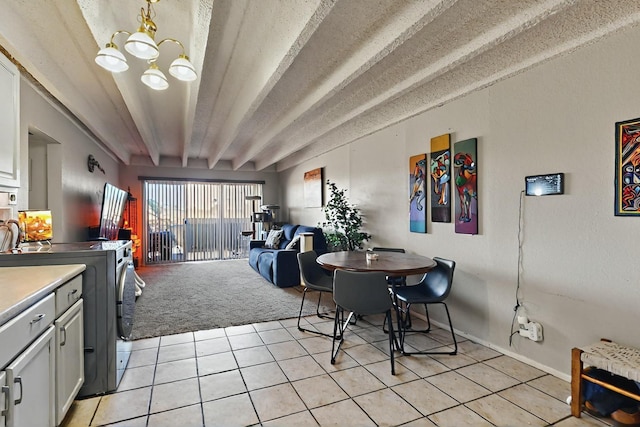 dining space with an inviting chandelier, light carpet, a textured ceiling, baseboards, and light tile patterned floors