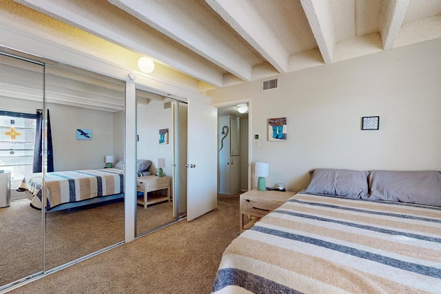 bedroom featuring beamed ceiling, carpet flooring, and visible vents