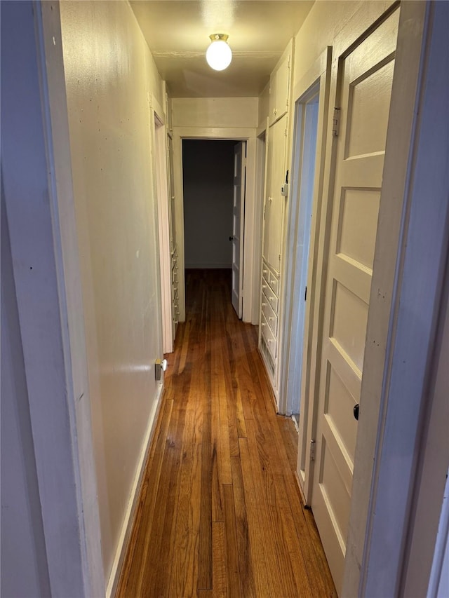 corridor with dark wood-style floors