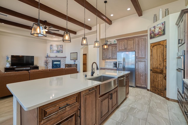 3415 Ramadan Ct NE, Rio Rancho, NM 87144 - kitchen with stainless steel appliances, a ceiling fan, open floor plan, and a sink