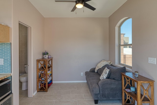 3415 Ramadan Ct NE, Rio Rancho, NM 87144 - living area with light tile patterned floors, baseboards, and a ceiling fan