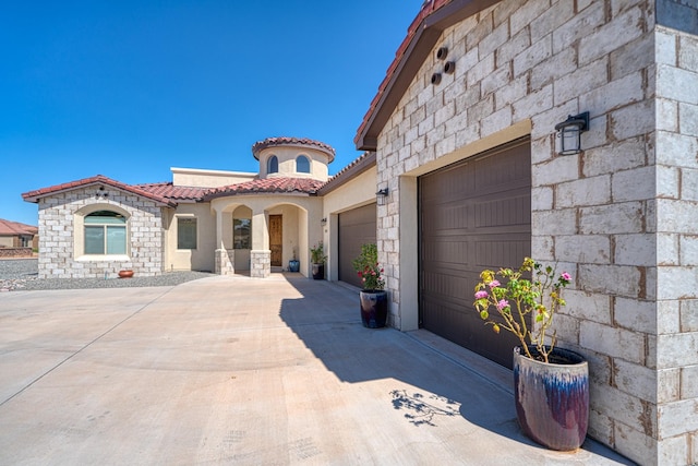 3415 Ramadan Ct NE, Rio Rancho, NM 87144 - mediterranean / spanish house featuring stone siding, stucco siding, a tiled roof, an attached garage, and driveway