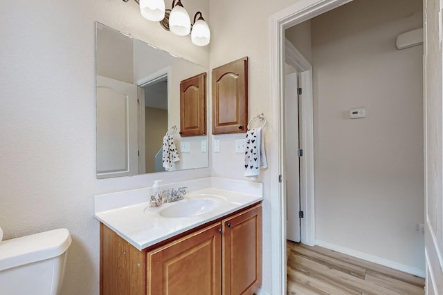 4359 San Benito St Unit B, Santa Fe, NM 87507 - bathroom featuring vanity, toilet, baseboards, and wood finished floors