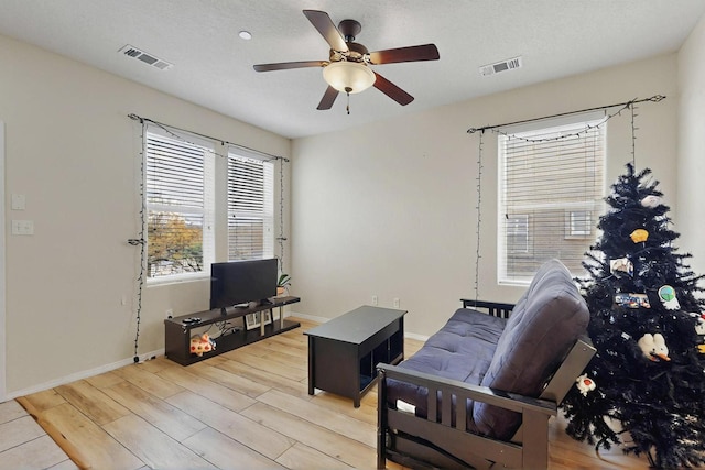 4359 San Benito St Unit B, Santa Fe, NM 87507 - living room featuring light wood-style floors, visible vents, baseboards, and a ceiling fan