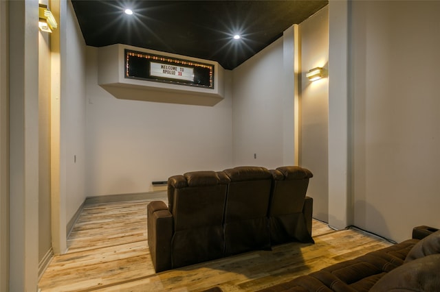 cinema room with wood finished floors and recessed lighting
