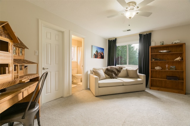 interior space with a ceiling fan, carpet flooring, and visible vents