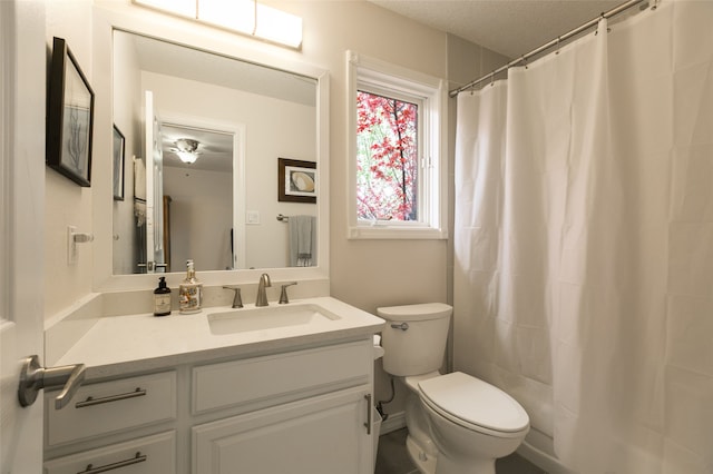 full bath with vanity, toilet, a textured ceiling, and a shower with curtain