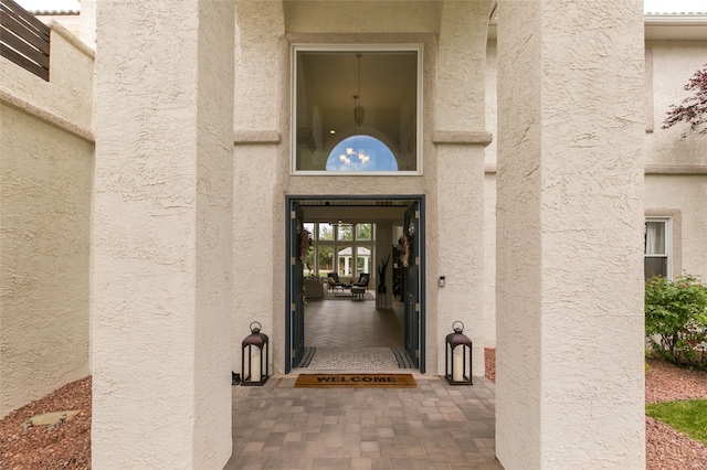 entrance to property with stucco siding