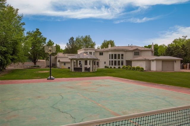 view of sport court featuring a lawn