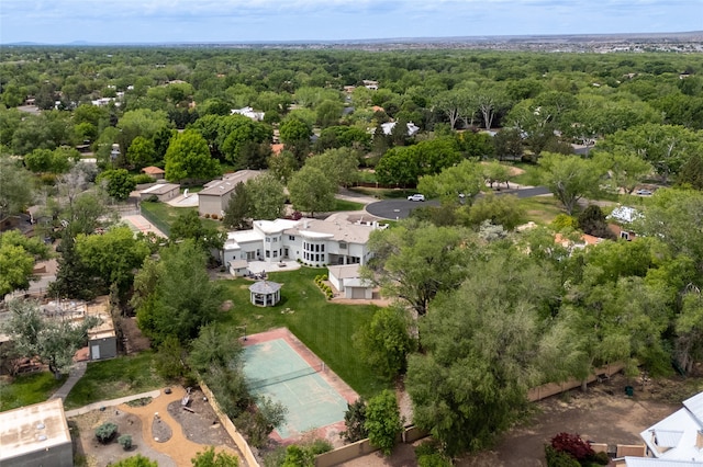drone / aerial view with a wooded view