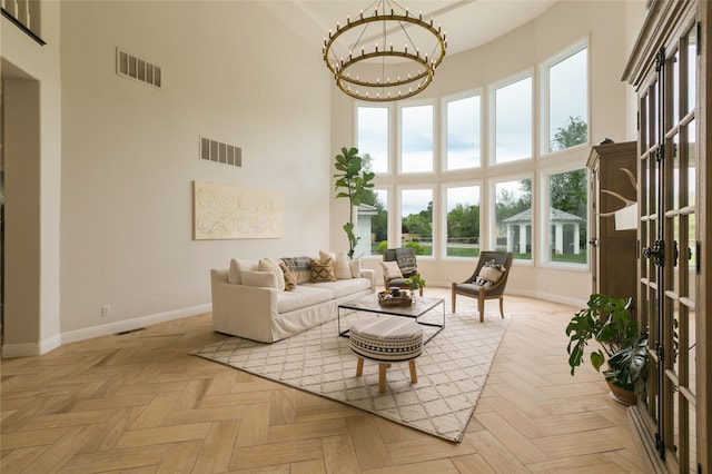 sunroom / solarium featuring a chandelier and visible vents