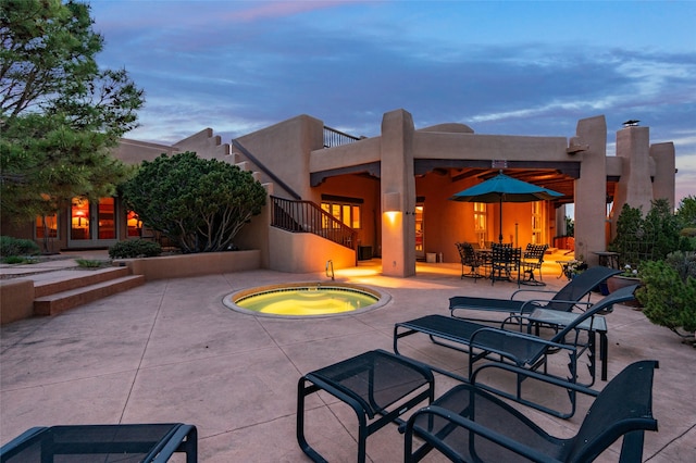 view of patio featuring an in ground hot tub