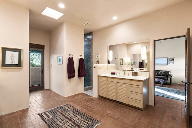 full bath with vanity, brick floor, a shower stall, and recessed lighting