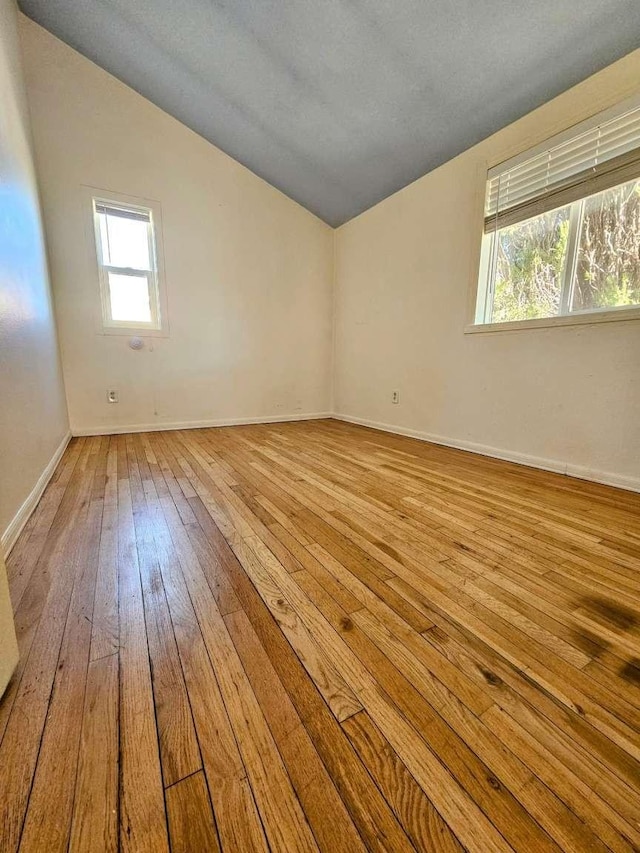 3546 Questa Dr, Los Alamos, NM 87544 - unfurnished room featuring vaulted ceiling, baseboards, and hardwood / wood-style floors