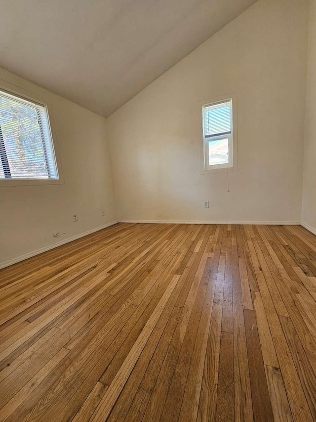 3546 Questa Dr, Los Alamos, NM 87544 - spare room featuring lofted ceiling, baseboards, a healthy amount of sunlight, and wood-type flooring