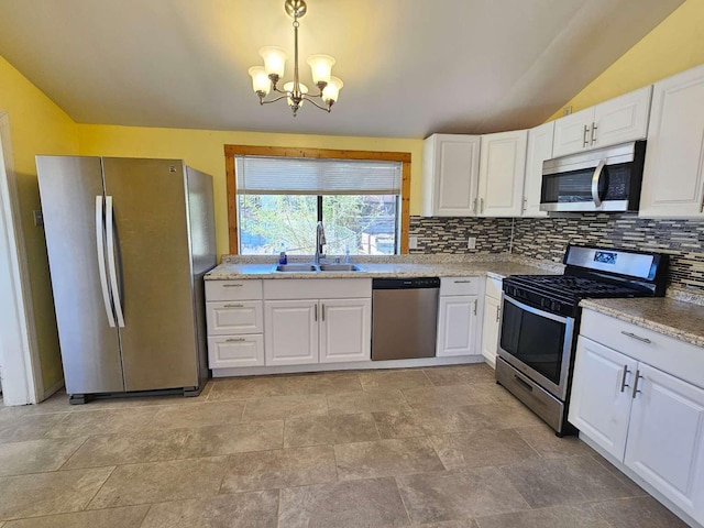 3546 Questa Dr, Los Alamos, NM 87544 - kitchen featuring a sink, stainless steel appliances, decorative backsplash, a chandelier, and lofted ceiling