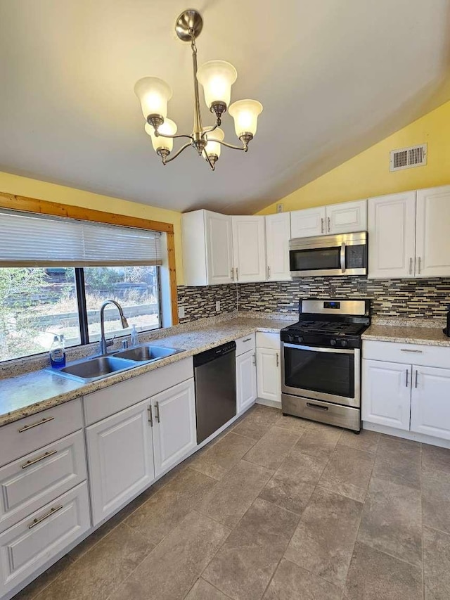 3546 Questa Dr, Los Alamos, NM 87544 - kitchen featuring an inviting chandelier, visible vents, a sink, vaulted ceiling, and appliances with stainless steel finishes