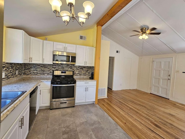 3546 Questa Dr, Los Alamos, NM 87544 - kitchen featuring stainless steel appliances, white cabinets, decorative backsplash, and vaulted ceiling with beams