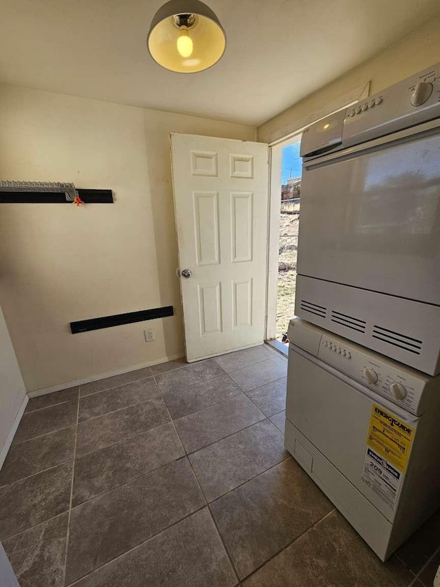 3546 Questa Dr, Los Alamos, NM 87544 - interior space with baseboards, stacked washer / dryer, and dark tile patterned floors