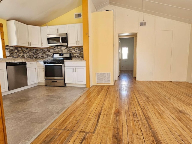 3546 Questa Dr, Los Alamos, NM 87544 - kitchen with vaulted ceiling, appliances with stainless steel finishes, visible vents, and white cabinetry