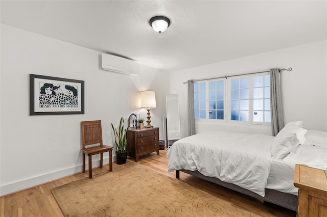 540/542 Franklin Ave, Santa Fe, NM 87501 - bedroom featuring baseboards, a wall unit AC, and light wood-style floors