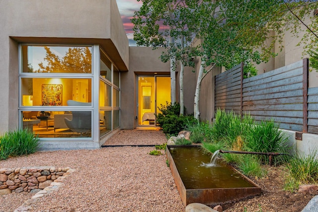 161 S Armijo Ln, Santa Fe, NM 87501 - exterior entry at dusk featuring fence and stucco siding
