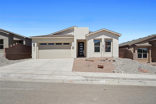 85 Cadena Blvd, Los Alamos, NM 87547 - view of front facade with stucco siding, a garage, driveway, and fence