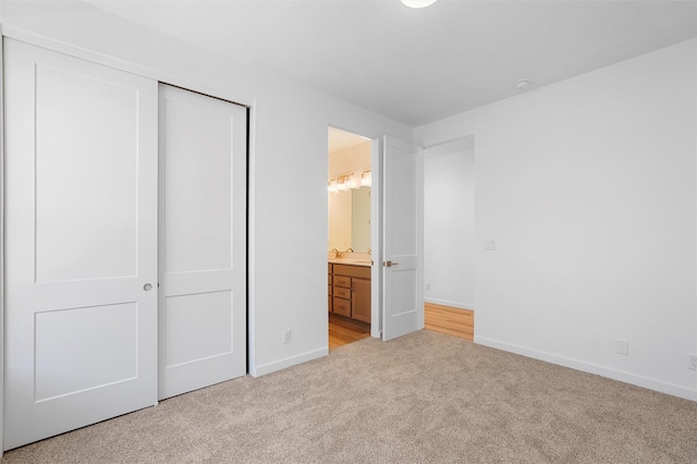 85 Cadena Blvd, Los Alamos, NM 87547 - unfurnished bedroom with light carpet, a closet, baseboards, and connected bathroom