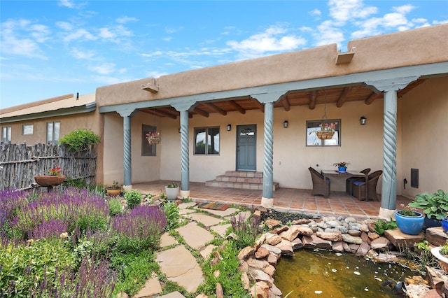 1 Azul Pl, Santa Fe, NM 87508 - rear view of house featuring a patio, stucco siding, and a garden pond