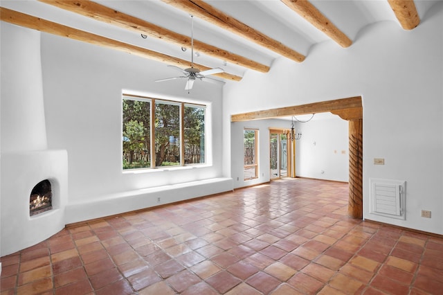 1 Azul Pl, Santa Fe, NM 87508 - unfurnished living room featuring a fireplace, beam ceiling, a ceiling fan, baseboards, and tile patterned floors