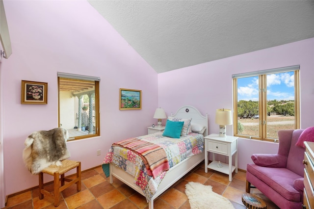 1 Azul Pl, Santa Fe, NM 87508 - bedroom featuring a textured ceiling, lofted ceiling, and baseboards