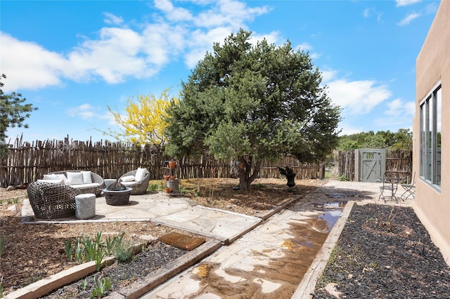 1 Azul Pl, Santa Fe, NM 87508 - fenced backyard with a patio and an outdoor living space with a fire pit