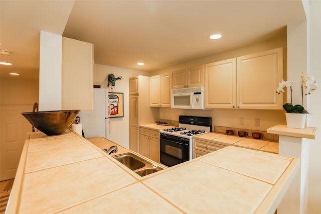 663 Bishops Lodge Rd Unit 71, Santa Fe, NM 87501 - kitchen featuring white appliances, a sink, tile countertops, recessed lighting, and white cabinets