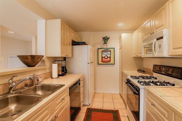 663 Bishops Lodge Rd Unit 71, Santa Fe, NM 87501 - kitchen with white appliances, a sink, tile counters, light tile patterned floors, and recessed lighting