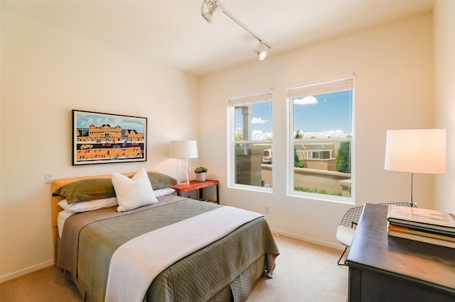 663 Bishops Lodge Rd Unit 71, Santa Fe, NM 87501 - bedroom with light colored carpet, rail lighting, baseboards, and a desk