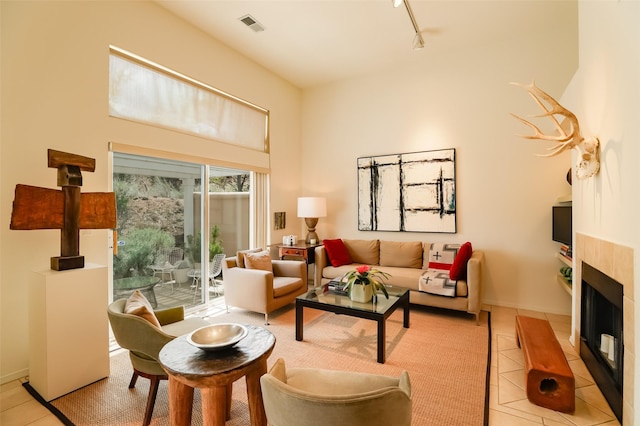 663 Bishops Lodge Rd Unit 71, Santa Fe, NM 87501 - living room featuring light tile patterned flooring, track lighting, and a fireplace