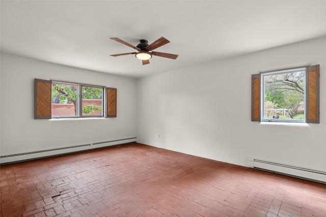 empty room featuring baseboard heating, ceiling fan, and brick patterned floors