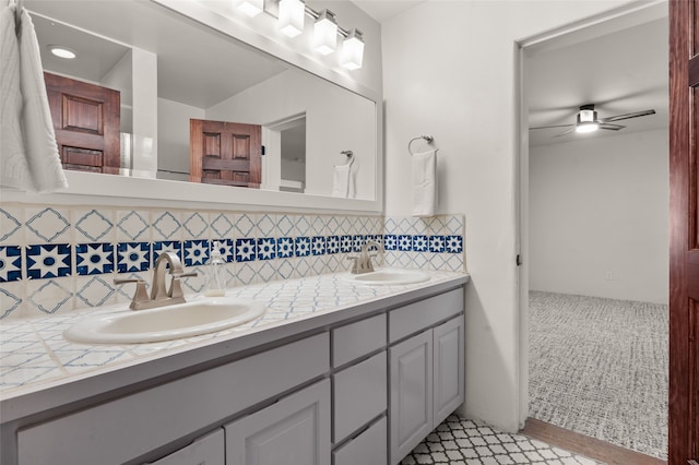 full bath featuring decorative backsplash, ceiling fan, and double vanity