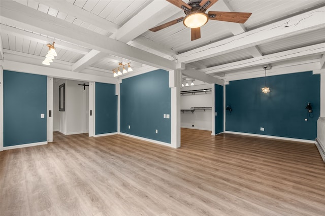 empty room with beamed ceiling, wood finished floors, baseboards, ceiling fan, and wooden ceiling