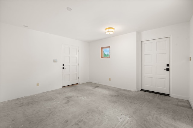 empty room featuring unfinished concrete floors
