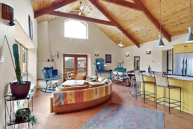 25A Lime Kiln Rd, Lamy, NM 87540 - living area featuring high vaulted ceiling, wood ceiling, brick floors, ceiling fan, and beam ceiling