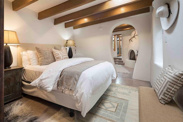 942 Canyon Unit A & B, Santa Fe, NM 87501 - bedroom with beamed ceiling, arched walkways, and concrete floors
