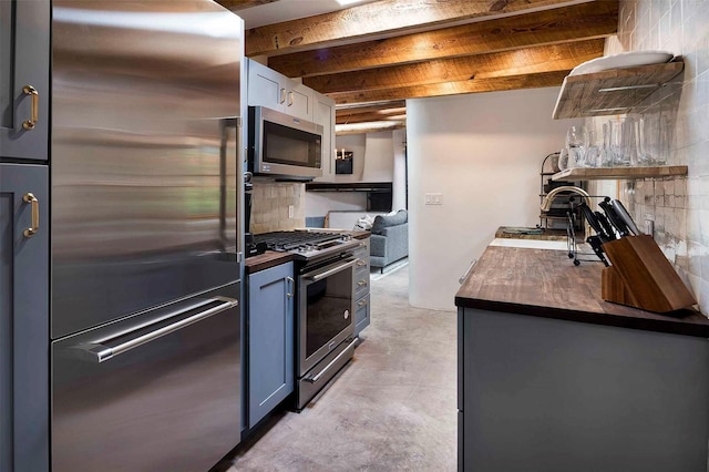942 Canyon Unit A & B, Santa Fe, NM 87501 - kitchen featuring stainless steel appliances, a sink, finished concrete floors, beamed ceiling, and decorative backsplash