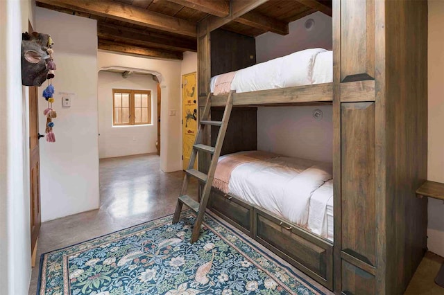 942 Canyon Unit A & B, Santa Fe, NM 87501 - bedroom with wood ceiling with exposed beams, finished concrete flooring, and arched walkways