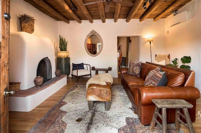 942 Canyon Unit A & B, Santa Fe, NM 87501 - living room featuring wooden ceiling with exposed beams, an AC wall unit, wood finished floors, ceiling fan, and a fireplace with raised hearth